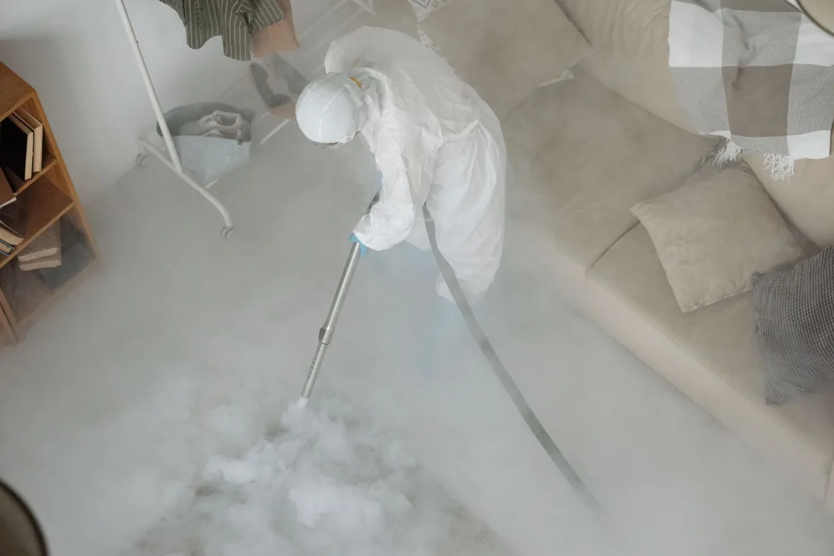 Biohazard cleanup technician in protective equipment, Salida del Sol Estates, TX